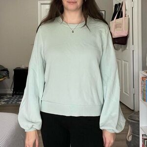 Light turquoise crewneck sweater with puffy statement sleeves